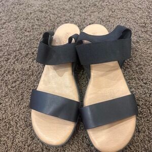 black leather sandals with elastic straps